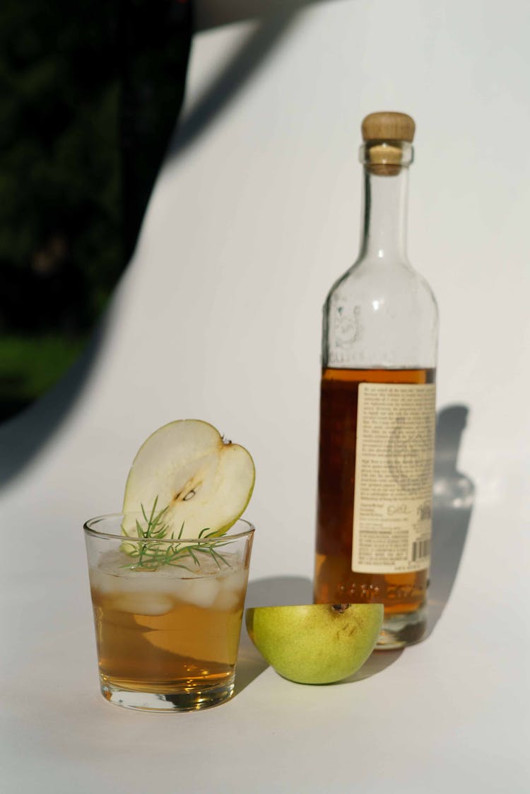 Bottle And Glass Of Pear Tincture In Studio