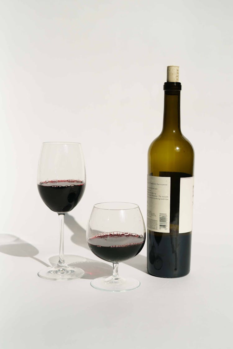 Bottle Of Red Wine Near Glasses In Studio