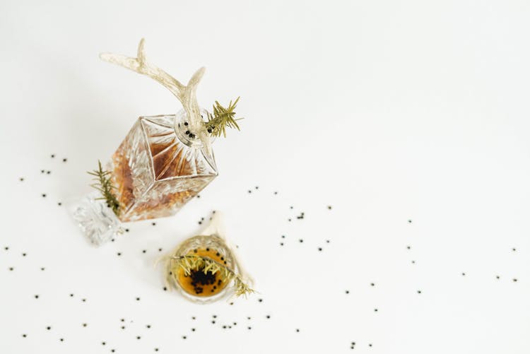 Decanter And Glass With Whiskey With Peppercorns