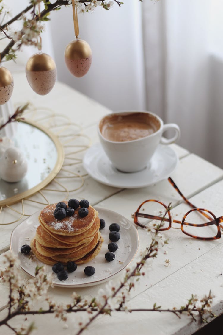 Tasty Pancakes And Coffee On Table During Easter Holiday