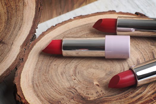 A stylish display of red lipsticks on a natural wooden surface, perfect for beauty and fashion themes.