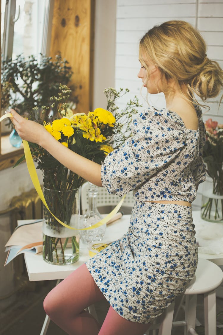 Florist With Yellow Ribbon In Workshop