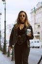 Stylish woman with coffee on street