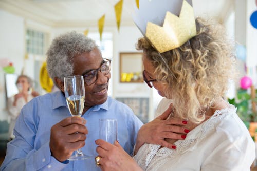 Free Elderly People Facing Each Other while Holding a Glass of Champagne Stock Photo