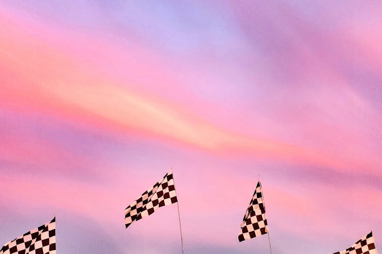 Checkered Flags Under Pink Sky