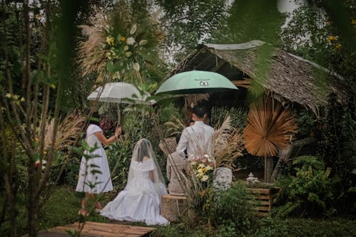 People Holding Umbrellas During Wedding Ceremony