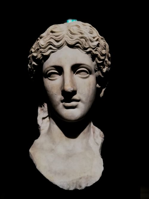 Free Greek statue bust with intricate details on a plain black background, showcasing ancient artistry. Stock Photo