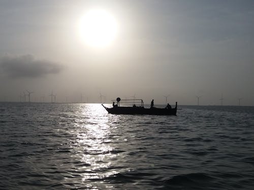 A Grayscale Photo of a Sailing Boat on the Sea