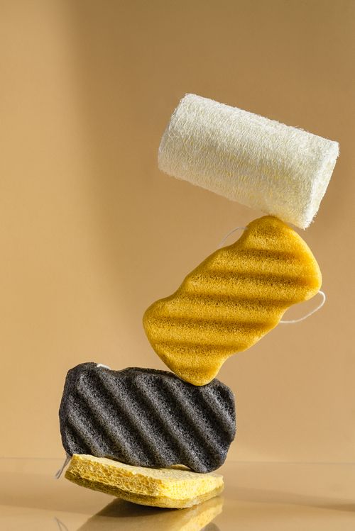 Free Vertical stack of colorful cleaning sponges on a neutral background. Stock Photo