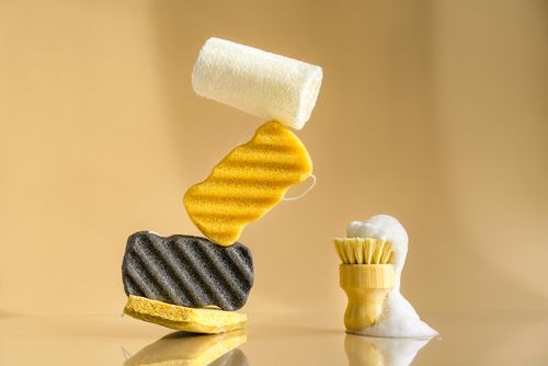 Free Artistic arrangement of bath sponges and brush with foam, perfect for spa or cleaning themes. Stock Photo