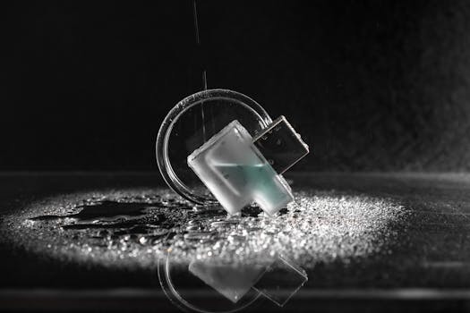 Minimalist close-up shot of a USB drive with water droplets on glass and dark background.