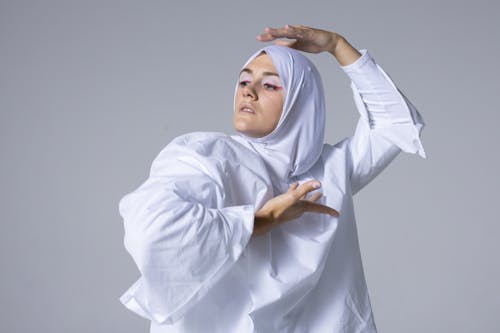 Woman in White Hijab and White Long Sleeve Top Posing