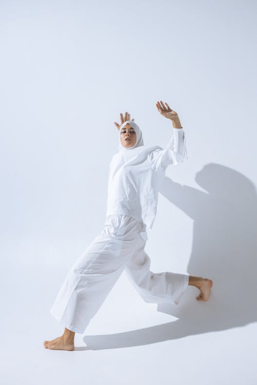 Woman Wearing White Hijab Leaning on a Wall