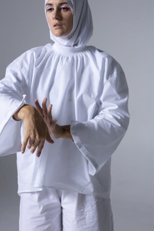 Man in White Long Sleeve Shirt and Hijab