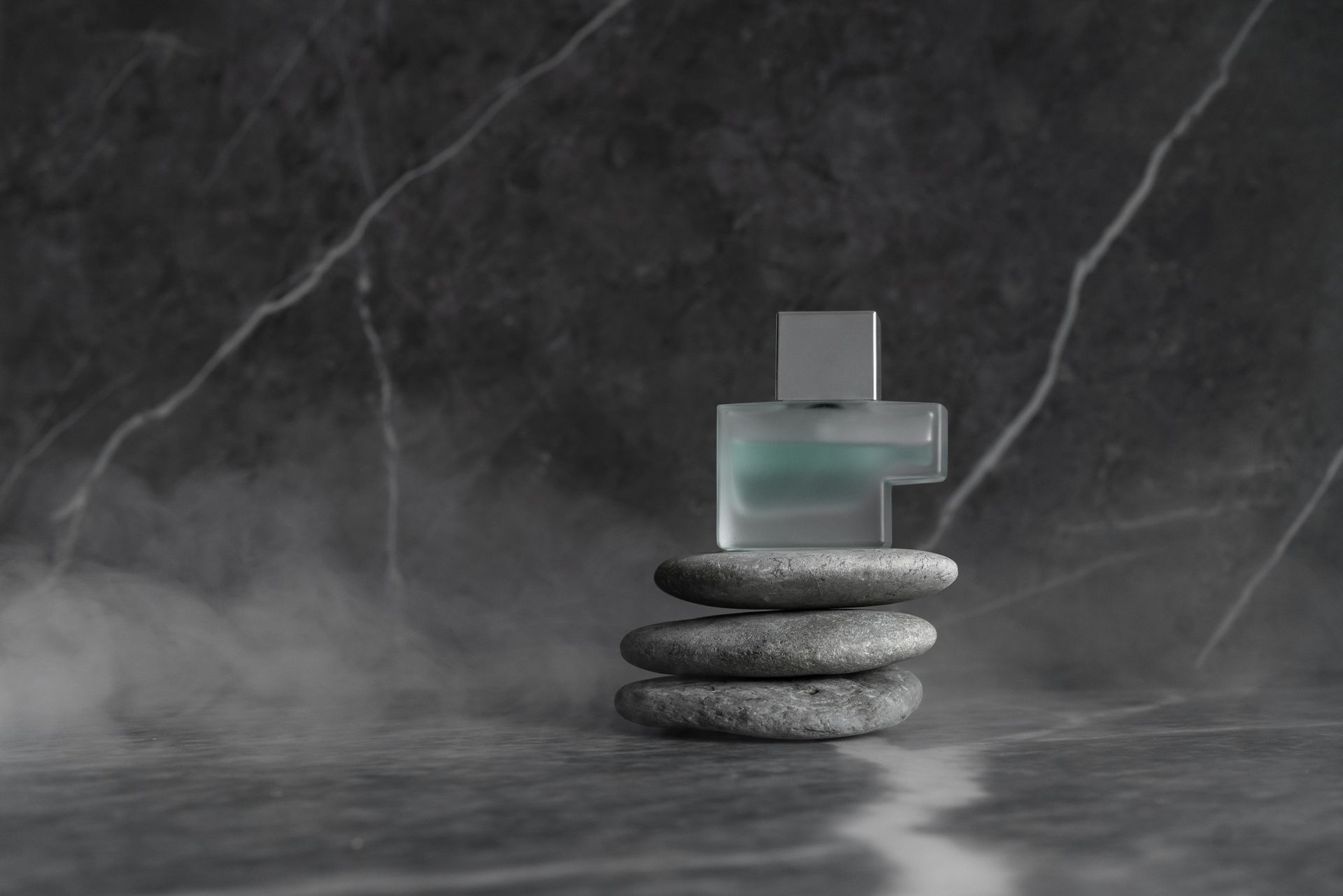 A Bottle of Perfume on Top of Stones