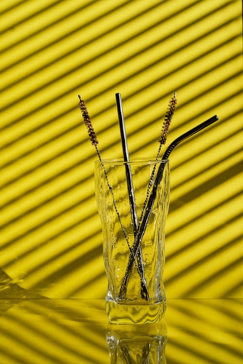 Black Straws and Brush Cleaner on a Glass