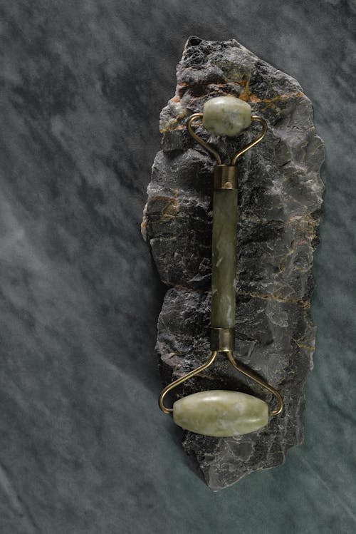 A Jade Roller on Top of a Stone