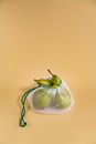 Green Pears Inside A Drawstring Net With Beige Background
