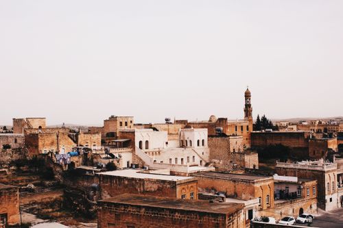 Free A picturesque view of a Middle Eastern city with rustic architecture during sunset. Stock Photo