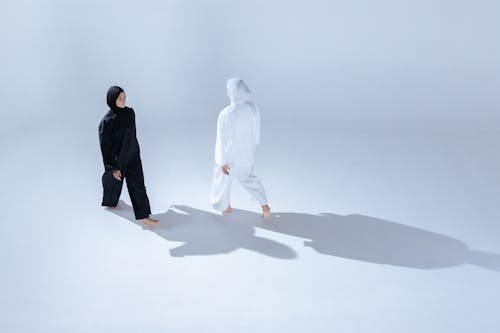 Women in Black and White Clothing Walking