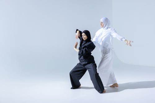 Women in White and Black Hijabs Dancing