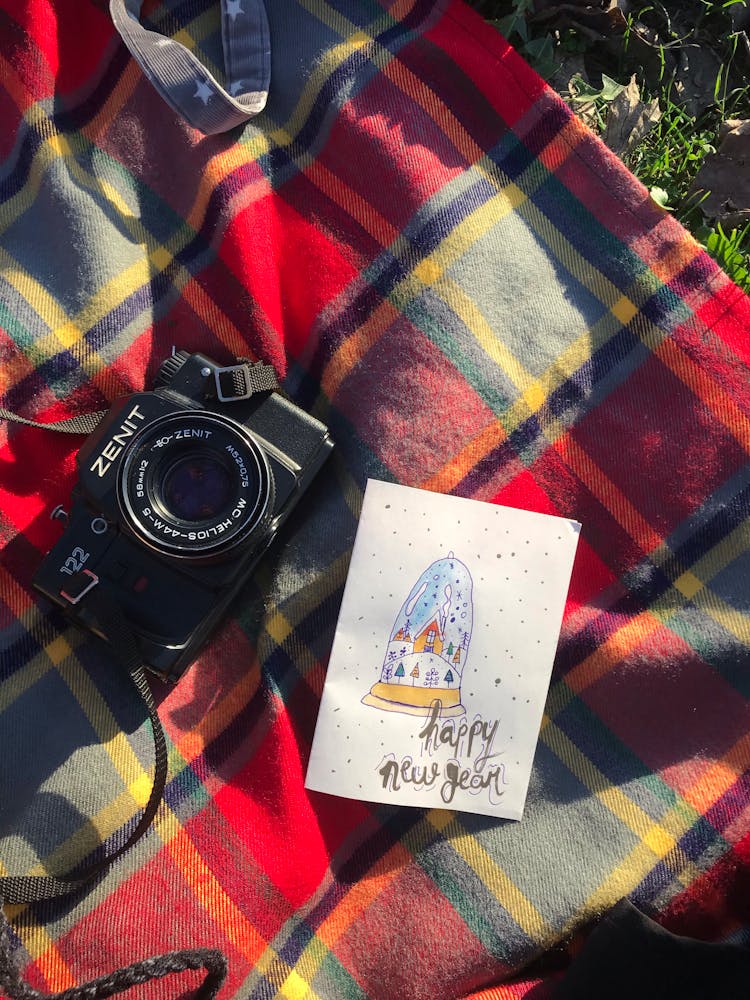 Overhead Shot Of A Black Camera Beside A Greeting Card