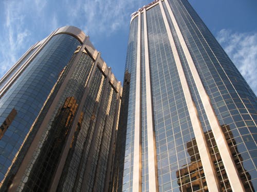 Low-Angle Shot of Two High-Rise Glass Walled Buildings