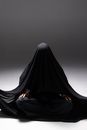 Person in Black Hijab Sitting on Black Chair