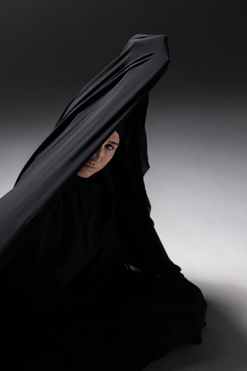 Woman in Black Hijab Sitting