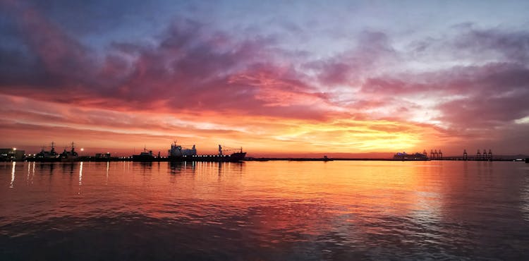 Silhouette Of Ships On The Port During Sunset