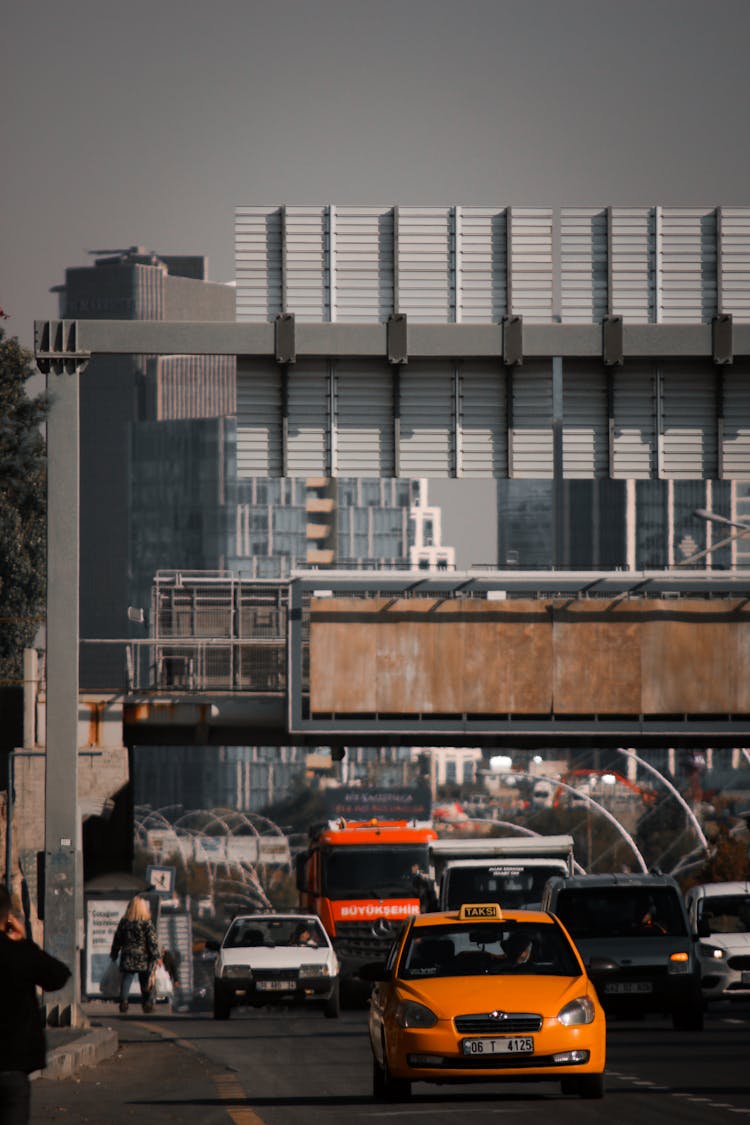 Cars Passing Under Gray Steel Structure