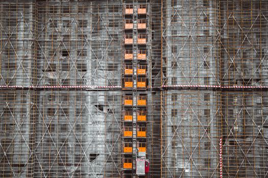 Detailed view of scaffolding on a construction site, featuring steel and concrete materials.