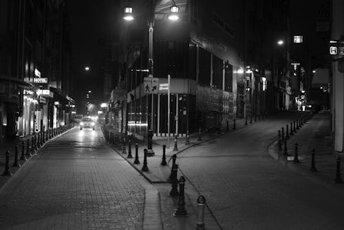 Grayscale Photo of People Walking on Sidewalk