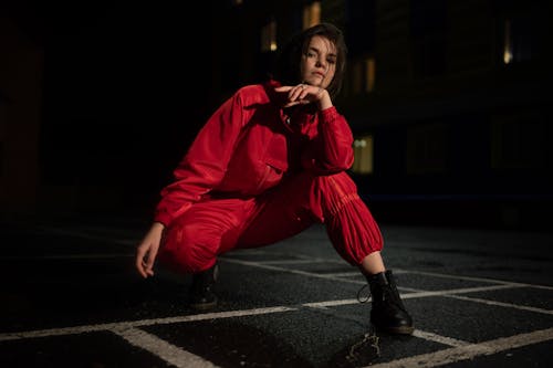 Free A Woman Wearing a Red Jacket Posing Stock Photo