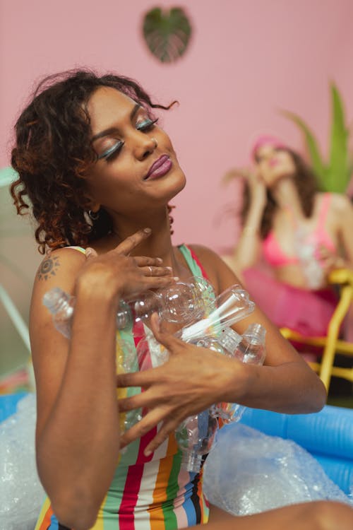 Woman Holding Plastic Bottles