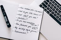 A Marker on Top of a Open Notebook