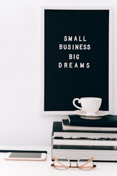 Minimalist workspace featuring motivational board, coffee, and books for productivity.