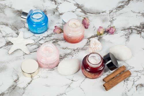 Close-Up Shot of Skin Care Products on a Marble Surface