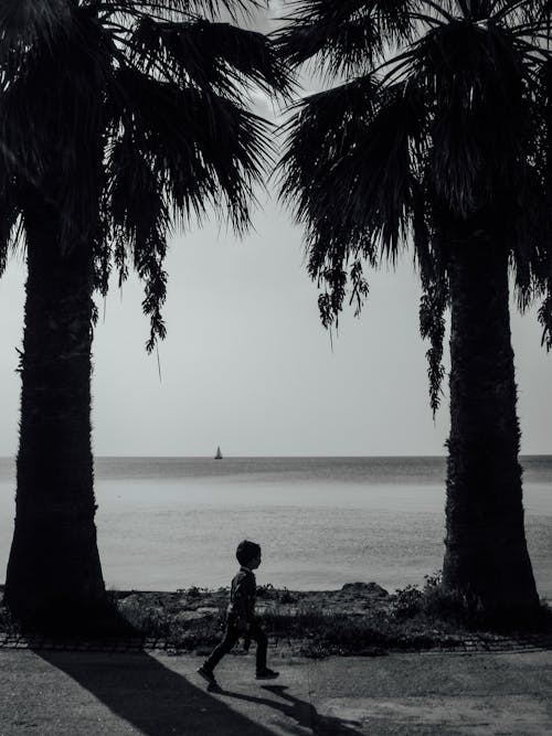 Black and White Photo of a Kid Running