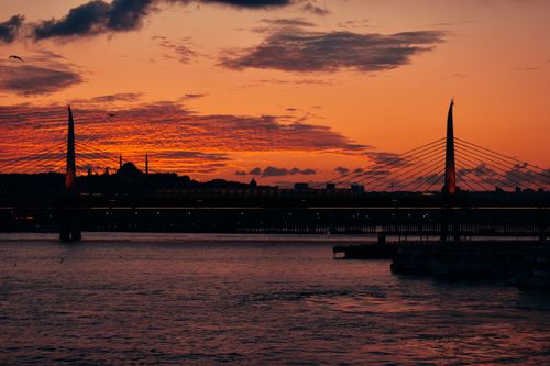 Free Beautiful sunset over the Golden Horn in Istanbul with the silhouette of a bridge and skyline. Stock Photo