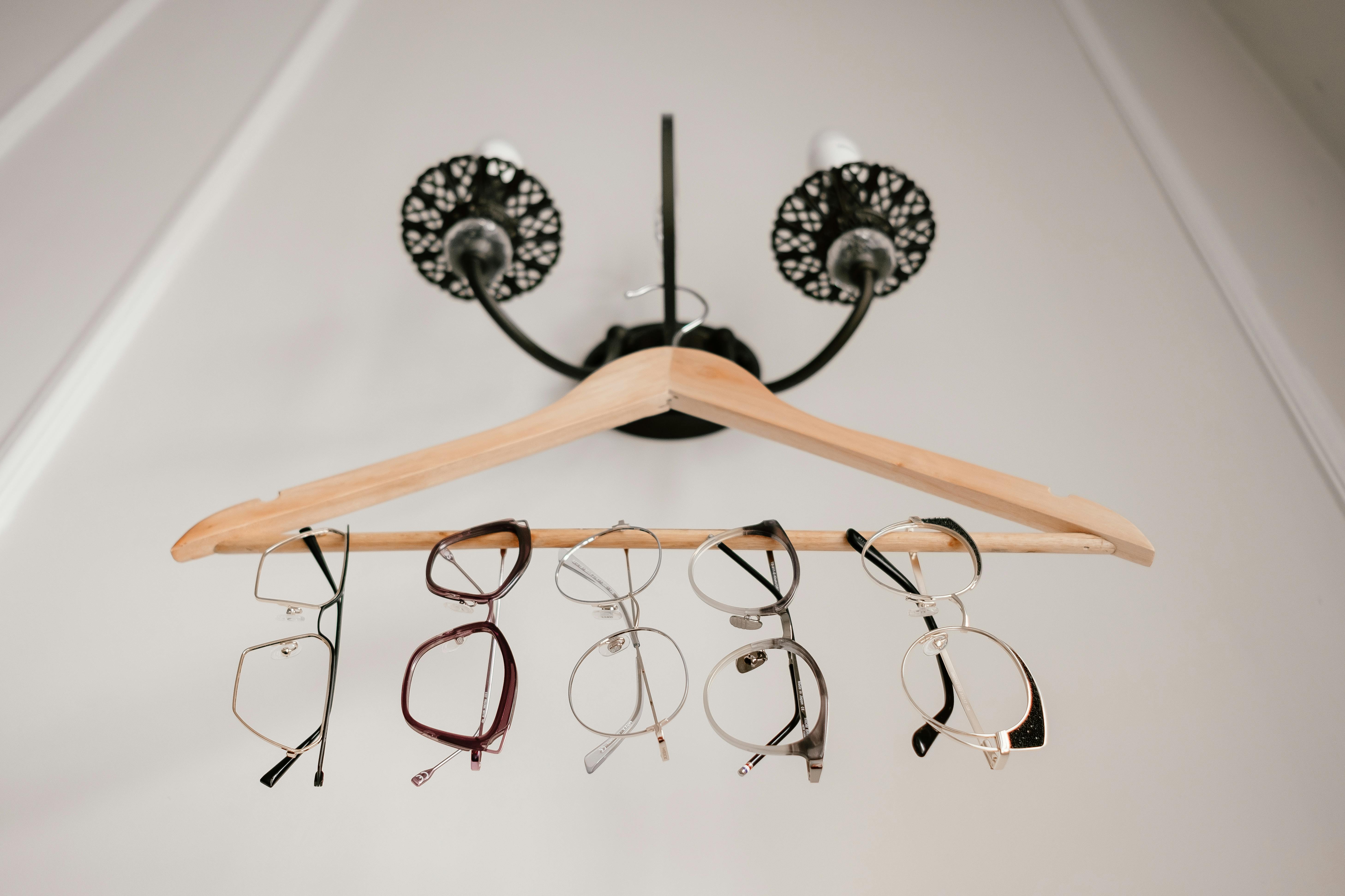 Eyeglasses hanging on a Wooden Hanger · Free Stock Photo