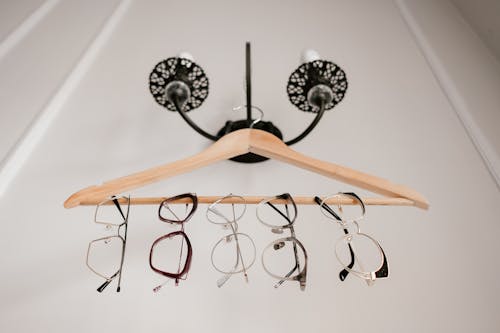 Eyeglasses hanging on a Wooden Hanger