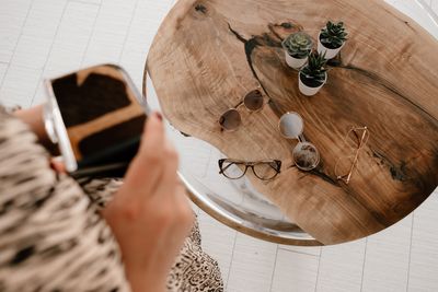 Eyeglasses and sunglasses on a rustic wooden table — Maria Ovchinnikova on Pexels