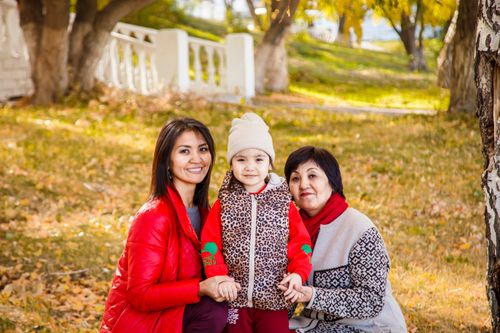 Free A happy family enjoying a sunny fall day outdoors, wearing jackets and smiling. Stock Photo