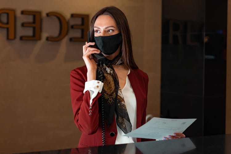 A Female Receptionist Having A Phone Call