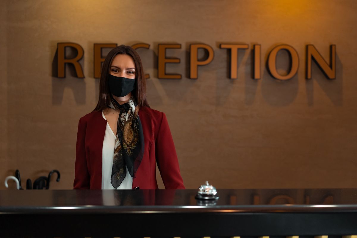 Hotel receptionist welcoming a guest