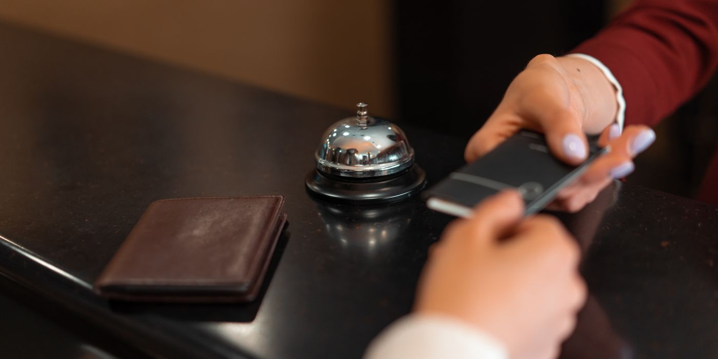 Traveler browsing last-minute hotel deals on a smartphone while planning a trip