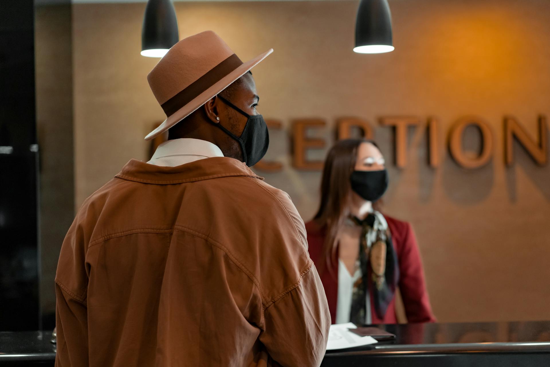 Man Walking Up to the Reception Desk