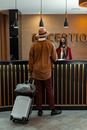 A Guest Talking to a Woman at the Reception Area