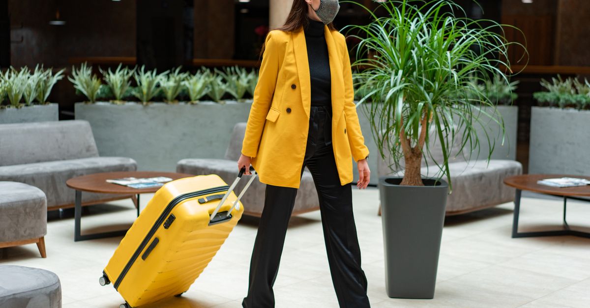 traveler struggling with luggage at an Airbnb lockbox vs. relaxing in a hotel lobby